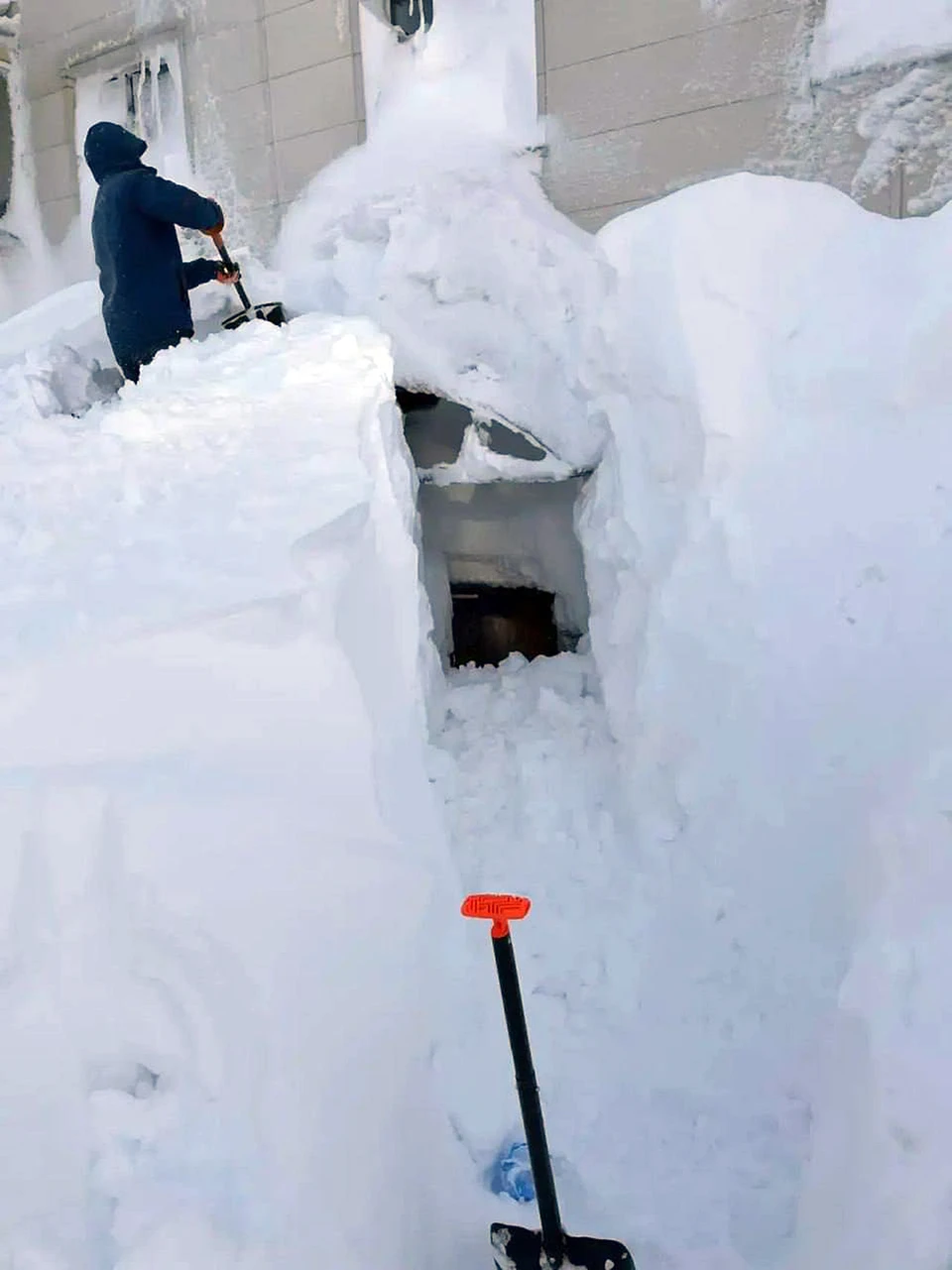 A composite screenshot of social-media posts and video stills showing deep snow around apartment blocks
